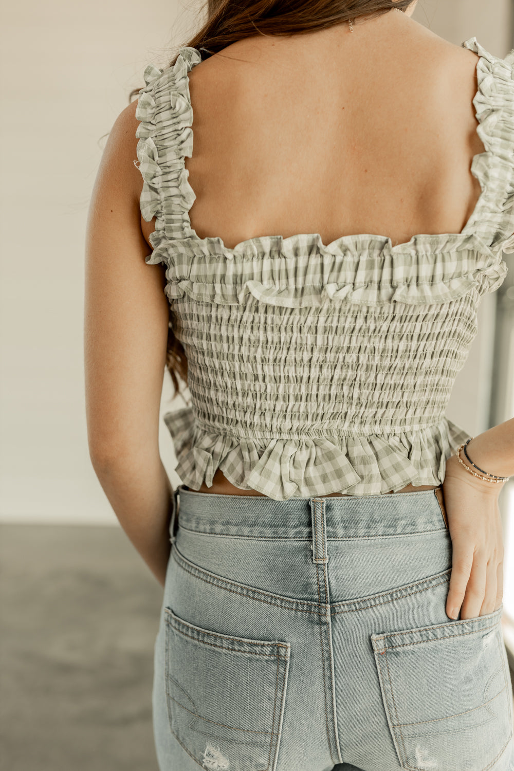 GINGHAM SLEEVELESS PEPLUM SMOCKED TOP